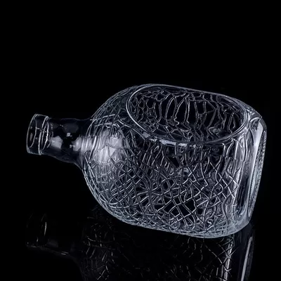 A 700ml, 750ml vodka glass bottle with a circular engraving on glass, a wine bottle with a cork seal