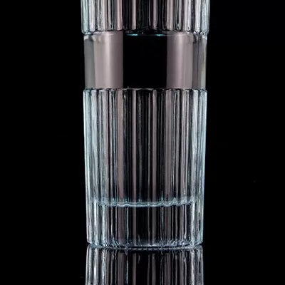 A beautiful light blue 750ml 75cl vertical bar vodka bottle with a cap made of transparent glass
