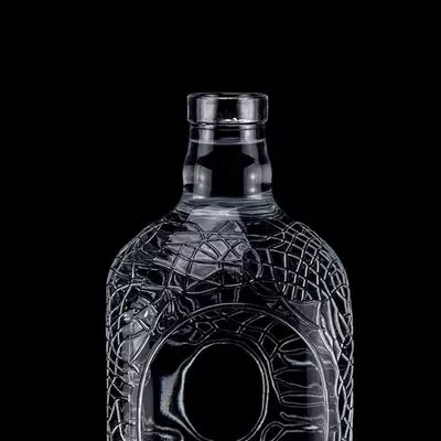 A 700ml, 750ml vodka glass bottle with a circular engraving on glass, a wine bottle with a cork seal
