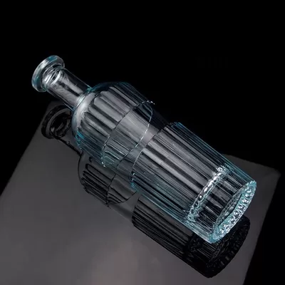 A beautiful light blue 750ml 75cl vertical bar vodka bottle with a cap made of transparent glass