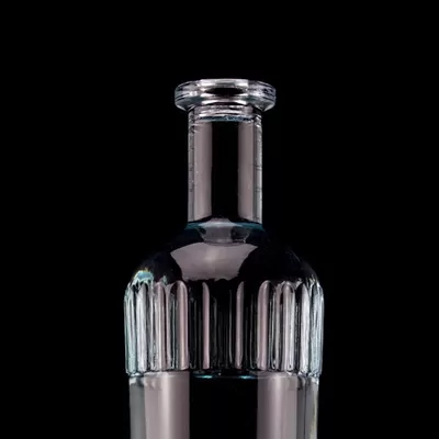 A beautiful light blue 750ml 75cl vertical bar vodka bottle with a cap made of transparent glass