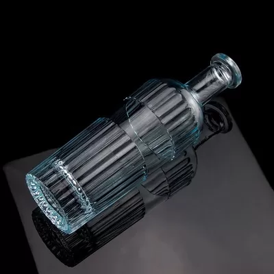 A beautiful light blue 750ml 75cl vertical bar vodka bottle with a cap made of transparent glass