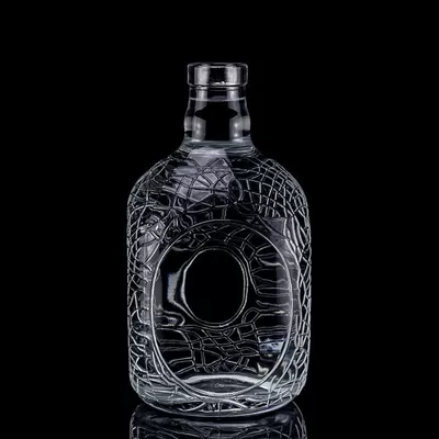 A 700ml, 750ml vodka glass bottle with a circular engraving on glass, a wine bottle with a cork seal