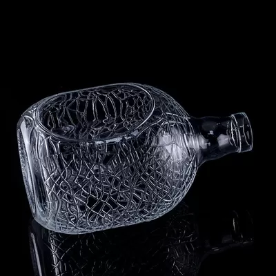 A 700ml, 750ml vodka glass bottle with a circular engraving on glass, a wine bottle with a cork seal