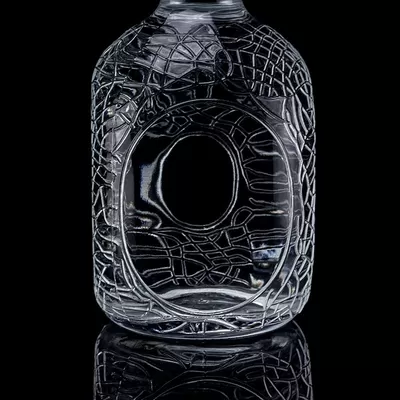 A 700ml, 750ml vodka glass bottle with a circular engraving on glass, a wine bottle with a cork seal